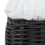 Close-up of cushion edge resting on dark woven ottoman frame