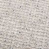 Close-up detail of Liv pillow fabric showing ivory base with small blue speckles and woven pattern