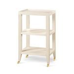 Isadora Side Table with light wood finish, three-tier shelves, tapered legs, and brass caster wheels