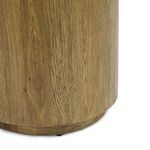 Detailed view of the plinth-style base showcasing its rounded shape and wood veneer finish