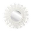 White lacquer starburst mirror with circular center and radiating irregular spikes with cut-out details