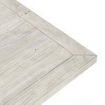 Close-up of table corner showing visible nail accents and wood surface texture