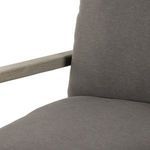 Close-up detail of chair backrest showing padded charcoal cushion edge against wooden frame