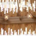 Underneath view showing clear bulbs and khaki metal hardware inside rattan shade