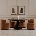 Four Dane swivel dining chairs arranged around a dark round dining table with white vase centerpiece