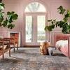 Alternate living room view with Giada Rug centered between wooden chairs and pink upholstered sofa