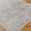 Close-up angled view of Darling Olive rug showing texture and intricate woven pattern on wood floor