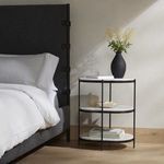 Close-up detail of marble shelves connected by thin powder-coated iron frame rods
