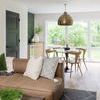 Satellite Rug styled in a modern living room under a coffee table beside a brown leather sofa
