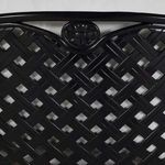 Detailed view of decorative floral motif on black aluminum lattice back