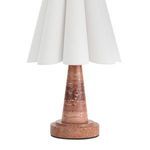 Close-up of tapered reddish natural marble lamp base showing smooth finish and natural pattern