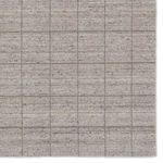 Tight detail of the grid pattern highlighting the woven yarn texture and color variation
