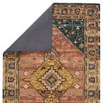 Rug flipped to show solid gray backing fabric and corner fold