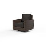 Montecito swivel rocker club chair with rich Cognac multi-colored resin wicker and dark cushions on a round metal base