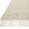 Close-up of one rug corner highlighting twisted fringed edging and woven texture