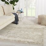 Rug styled in modern living room with sofa, side table, pouf, and large window with curtains