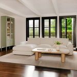 Alternate living room view of Berga sectional showing back-lit windows and green cabinet