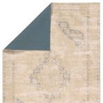 Corner flipped over revealing solid slate blue underside of the Sibit Medallion rug
