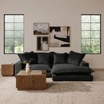 Living room scene featuring two Jasper accent tables with black sofa, art on walls, and large grid windows.