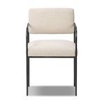 Fenn Dining Chair with slim hammered black iron frame, squared cream-colored upholstered seat and bolster back