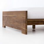 Angled close-up of bed footboard corner and joint detail on dark smoked oak