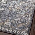 Detailed close-up of the rug’s soft textured pile with visible charcoal, gold, and light blue tones
