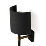 Maurice Sconce from diagonal side showing bulb inside curved shade and brass arm connection