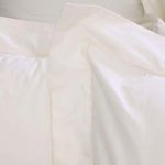 Close-up of hemstitch border detail on ivory cotton sateen duvet, highlighting fine stitching and fabric texture