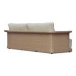 Rear angled view showing the woven wicker frame wrapping around the sofa's back and arms