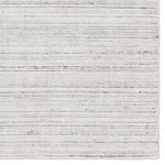 Zoomed-in area of rug highlighting soft pile texture with cream and black flecks in stripes