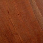 Close-up of dark chestnut wood grain and smooth tabletop texture on Sterling Side Table