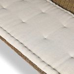Diagonal close-up showing tufted cushion surface with textured beige fabric