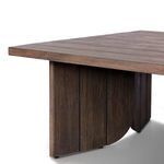 Angled close-up of table corner showing plank seam and curved base detail