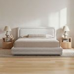 Styled bedroom scene with Tory Pebble Bed set with beige bedding and flanked by light wood nightstands and lamps