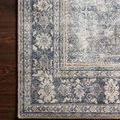 Close-up of rug corner on wooden floor highlighting fine floral border pattern and weave texture