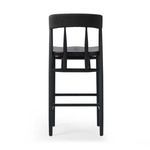 Side close-up showing smooth black oak seat edge contour and leg bracing on the Buxton Drifted Oak Bar Stool