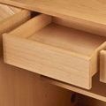 Opened drawer in wooden credenza showing smooth light oak interior craftsmanship