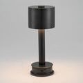 Black charging base with cable coiled neatly beside plug for Traverse Cordless Table Lamp