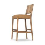 Angled side view showing seat thickness and tapered legs with footrest bars