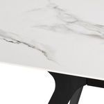 Close-up of white ceramic tabletop with subtle gray veining and corner of black metal leg