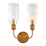 Two-light wall sconce with tall etched glass shades featuring scalloped edges and a round beaded brass backplate
