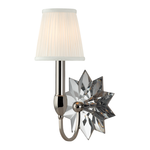 Wall sconce featuring a white pleated lampshade and a faceted starburst clear glass backplate with a polished silver arm