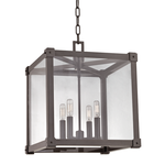 Forsyth 4 Light Pendant with a dark metal frame and clear glass panels in a cube shape, featuring four exposed bulbs inside