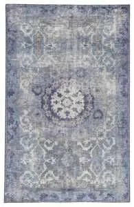 Top-down view displaying full vintage medallion pattern and cool-toned color variation of rug.