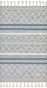 Sawyer Teal Rug with bold, tonal geometric patterns and playful fringe in a blue and cream color palette