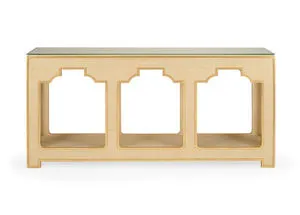 Cream colored raffia console table with gold accents and a clear tempered glass top, rectangular shape