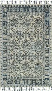 Blue and cream Zharah Mist rug with intricate geometric and floral hooked wool pile pattern and tasseled edges