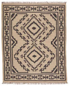 Handwoven flatweave tribal rug in beige and black with bold medallion and geometric border design
