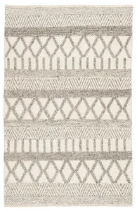 Rectangular handmade rug with gray and white tribal-inspired geometric patterns in Scandinavian wool design