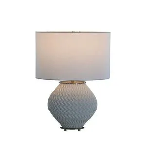 Sylvan Ceramic Small Table Lamp turned on with warm light shining through white drum shade